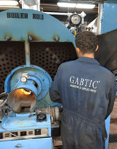 GABTIC technician servicing the burner of an industrial boiler