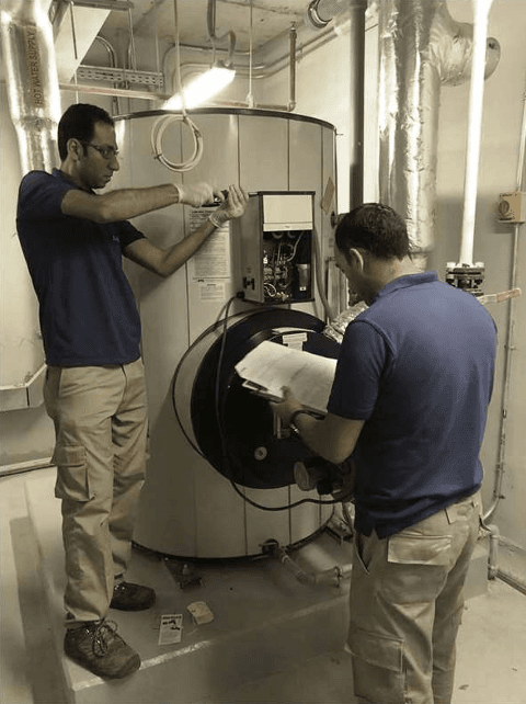 Two GABTIC technicians commissioning a commercial water heater